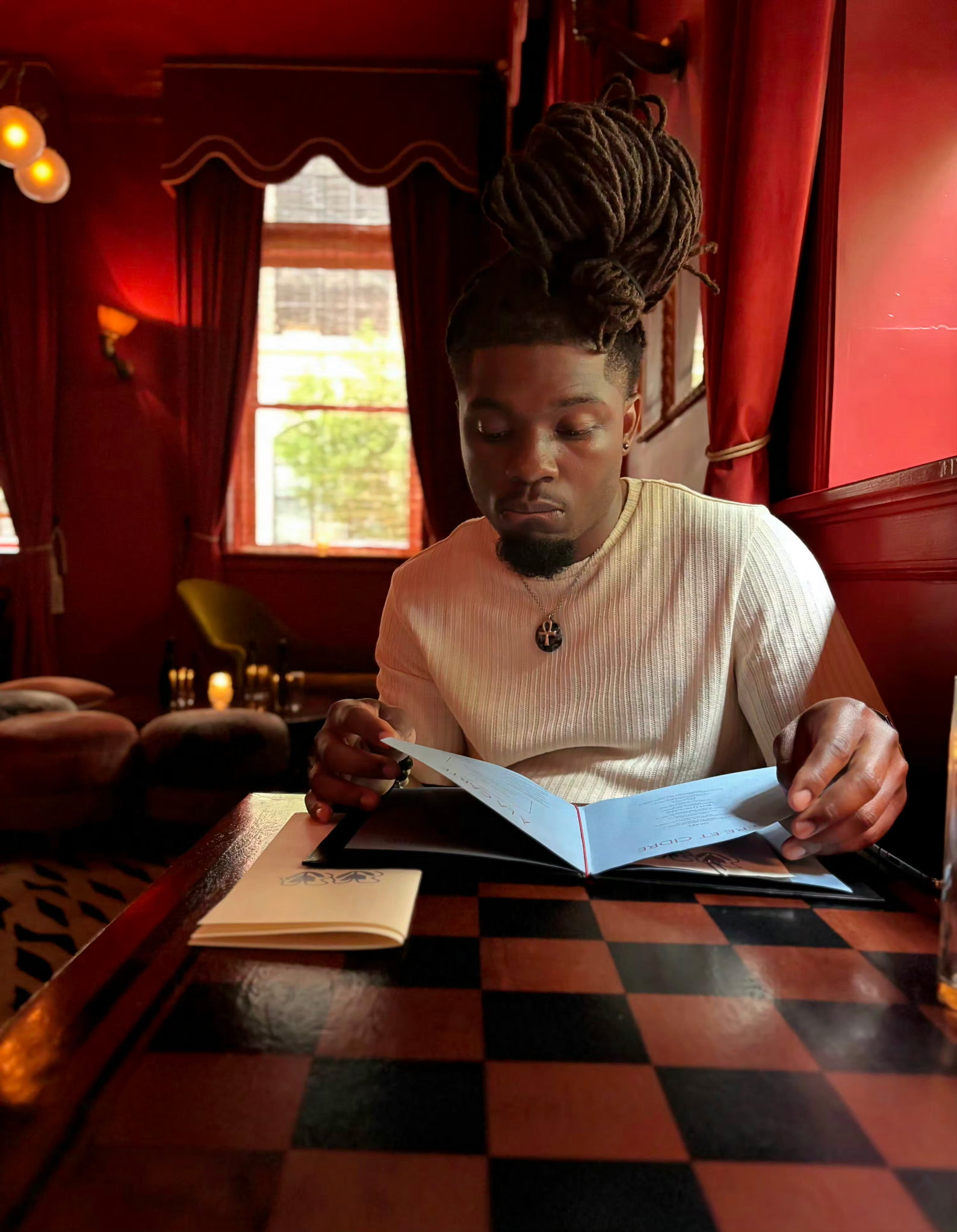 Artist seated in a red lounge
